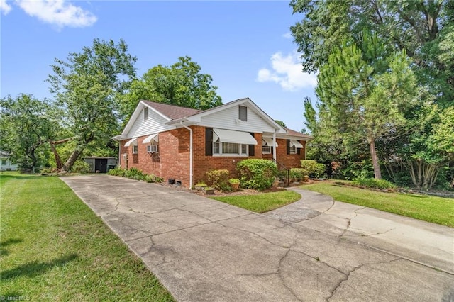 904 Ashe St, Greensboro, NC 27406 - view of front facade featuring brick siding, concrete driveway, and a front yard