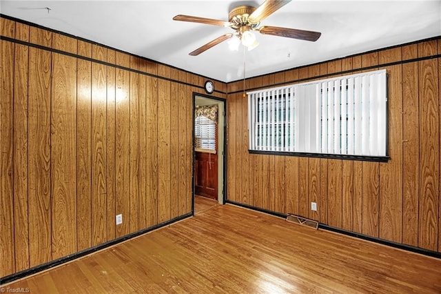 904 Ashe St, Greensboro, NC 27406 - empty room with a ceiling fan, wood finished floors, and wood walls