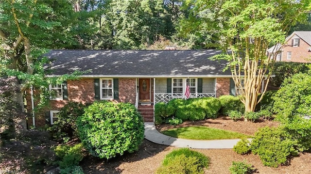 1603 Ilchester Ct, Greensboro, NC 27408 - view of front of house featuring a porch, brick siding, and roof with shingles