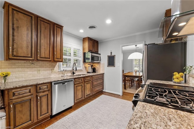 1603 Ilchester Ct, Greensboro, NC 27408 - kitchen with appliances with stainless steel finishes, ornamental molding, tasteful backsplash, wood finished floors, and recessed lighting