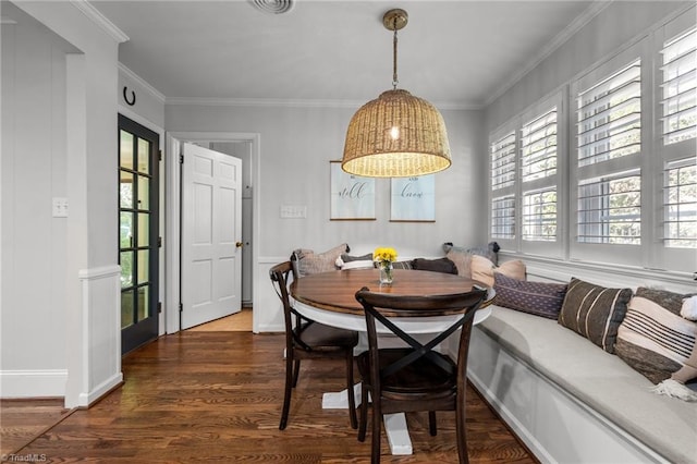 1603 Ilchester Ct, Greensboro, NC 27408 - dining space with breakfast area, plenty of natural light, dark wood-style floors, and crown molding
