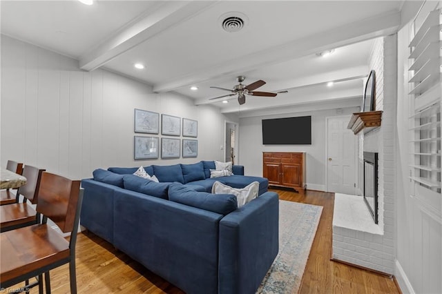 1603 Ilchester Ct, Greensboro, NC 27408 - living room with beam ceiling, a ceiling fan, wood finished floors, a brick fireplace, and recessed lighting