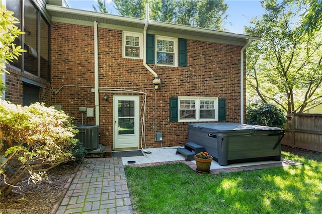 1603 Ilchester Ct, Greensboro, NC 27408 - rear view of house featuring a hot tub, a patio, and brick siding
