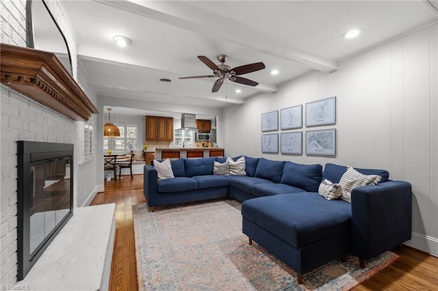 1603 Ilchester Ct, Greensboro, NC 27408 - living room featuring wood finished floors, a ceiling fan, a fireplace, beam ceiling, and recessed lighting