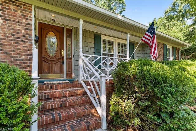 1603 Ilchester Ct, Greensboro, NC 27408 - doorway to property with brick siding and a porch
