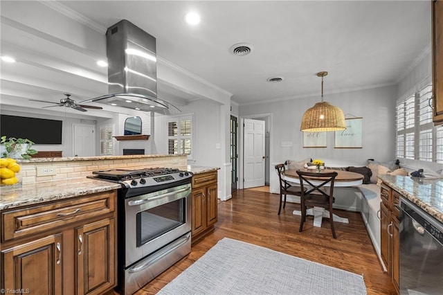 1603 Ilchester Ct, Greensboro, NC 27408 - kitchen featuring stainless steel appliances, island exhaust hood, brown cabinetry, open floor plan, and crown molding