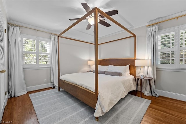1603 Ilchester Ct, Greensboro, NC 27408 - bedroom featuring multiple windows, wood finished floors, and ceiling fan
