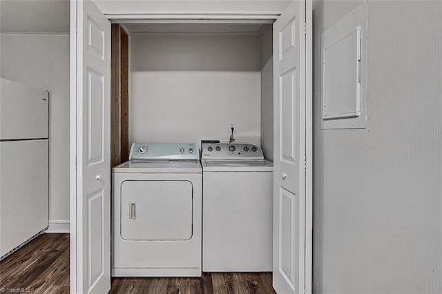 washroom featuring laundry area, dark wood-style flooring, electric panel, and washer and dryer