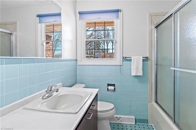 full bathroom with tile patterned flooring, toilet, vanity, visible vents, and tile walls