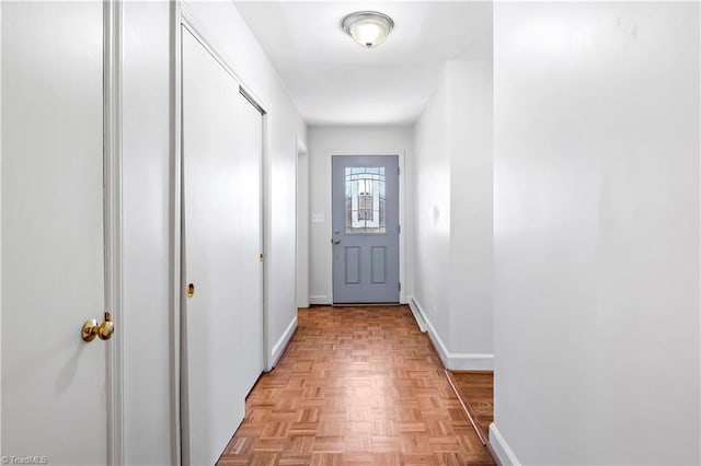 doorway to outside featuring baseboards