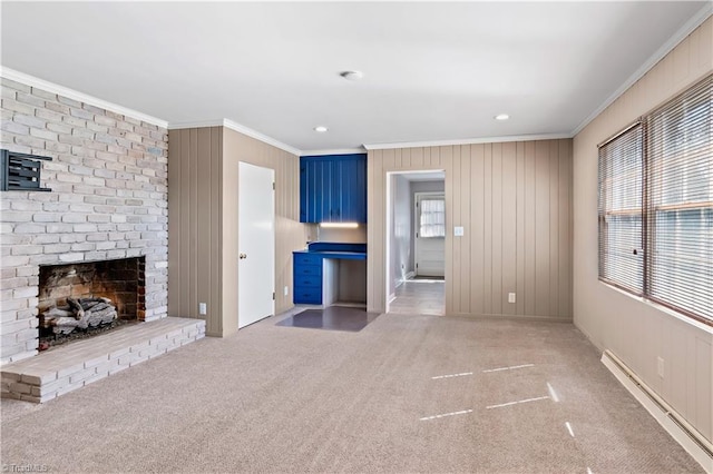 unfurnished living room with a baseboard radiator, recessed lighting, a fireplace, ornamental molding, and carpet