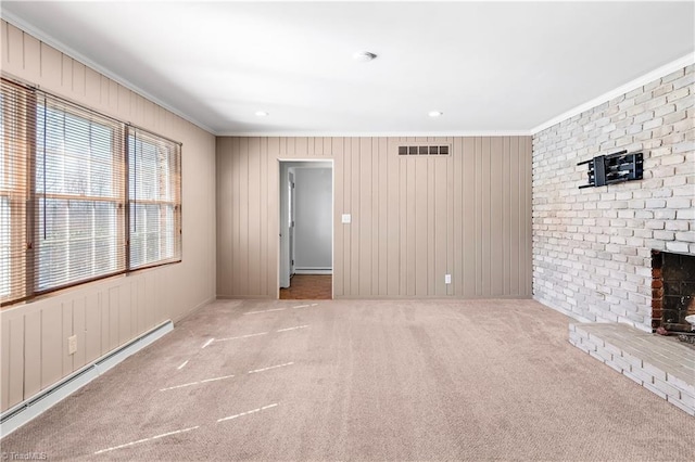 unfurnished living room with crown molding, visible vents, baseboard heating, a brick fireplace, and carpet flooring