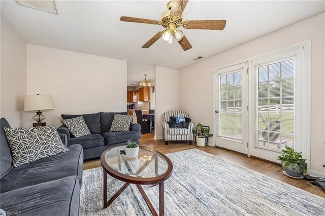 living room featuring ceiling fan and hardwood / wood-style floors