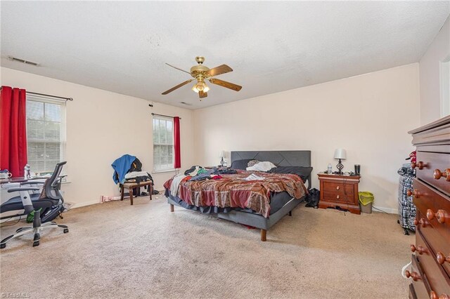 bedroom with multiple windows, carpet, and ceiling fan