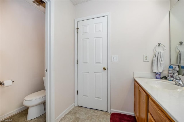 bathroom with tile patterned floors, vanity, and toilet