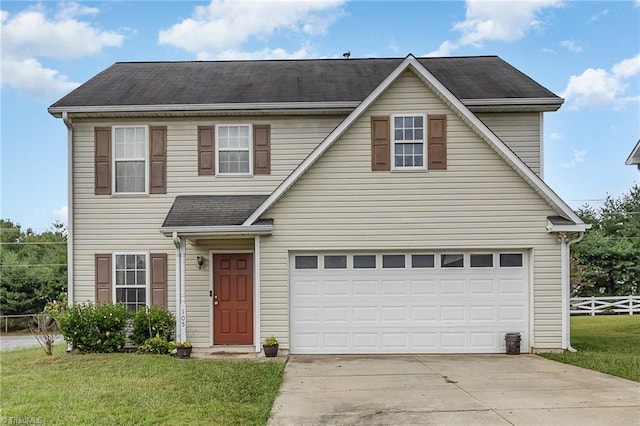 view of front of home with a garage and a front yard