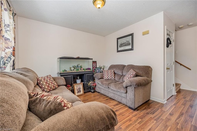 living room featuring a textured ceiling and hardwood / wood-style floors