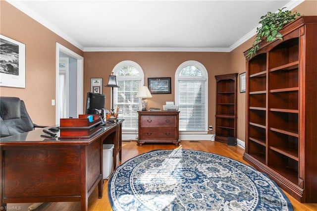 home office featuring light hardwood / wood-style floors and ornamental molding