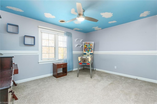 interior space featuring light carpet and ceiling fan