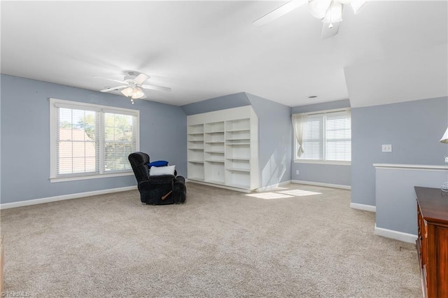 sitting room featuring light carpet and ceiling fan