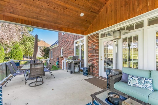 view of patio with an outdoor living space and a grill