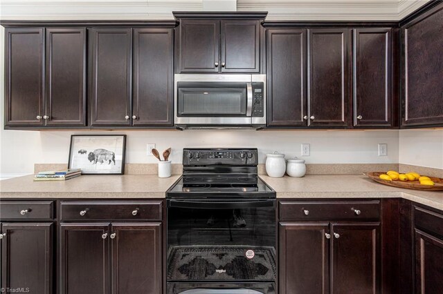 914 Bonanza Ln, Mebane, NC 27302 - kitchen with stainless steel microwave, dark brown cabinets, light countertops, and black range with electric stovetop