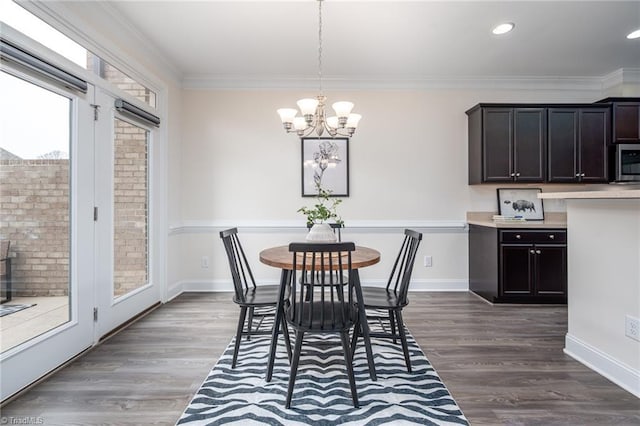 914 Bonanza Ln, Mebane, NC 27302 - dining area with a notable chandelier, crown molding, dark wood-type flooring, and baseboards