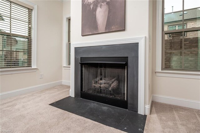 914 Bonanza Ln, Mebane, NC 27302 - details featuring carpet flooring, baseboards, and a fireplace with flush hearth