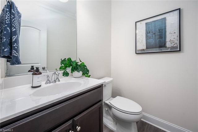 914 Bonanza Ln, Mebane, NC 27302 - bathroom featuring vanity, wood finished floors, baseboards, crown molding, and toilet