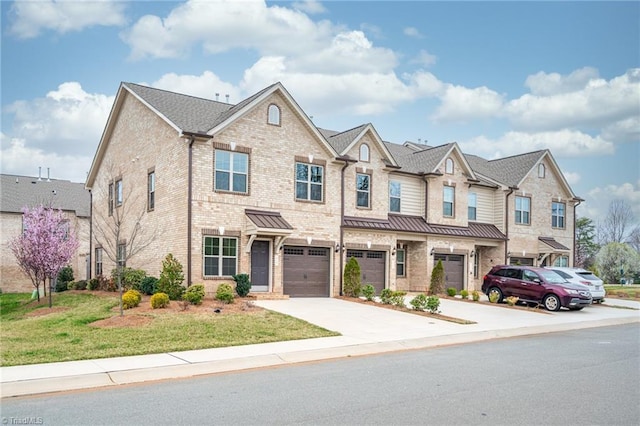 914 Bonanza Ln, Mebane, NC 27302 - view of property featuring a front lawn, driveway, a standing seam roof, an attached garage, and brick siding
