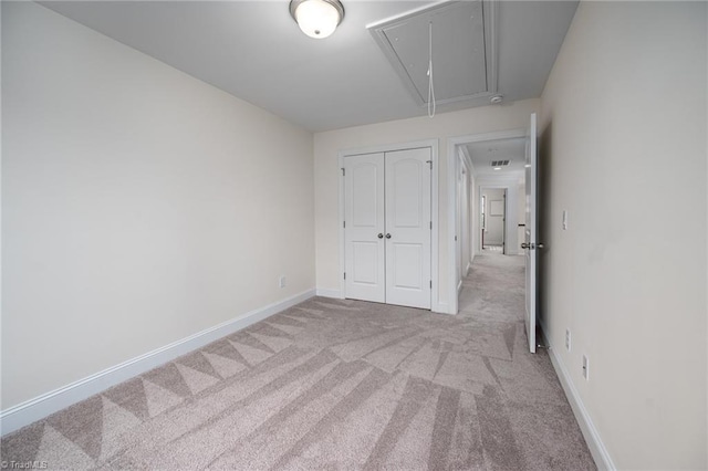 914 Bonanza Ln, Mebane, NC 27302 - unfurnished bedroom with a closet, baseboards, attic access, and carpet flooring