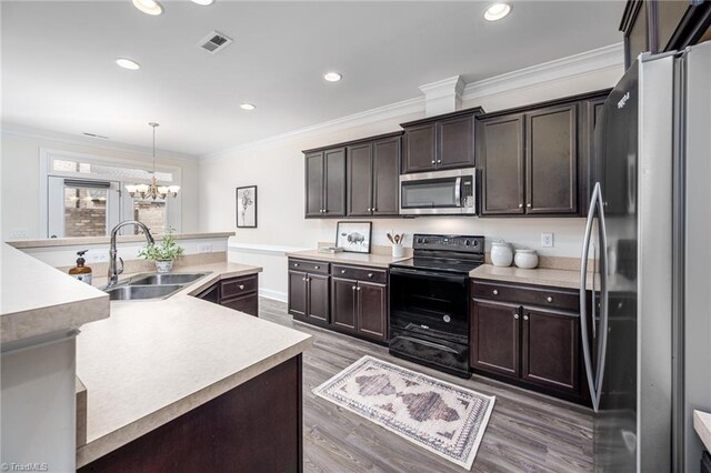 914 Bonanza Ln, Mebane, NC 27302 - kitchen with visible vents, a sink, appliances with stainless steel finishes, crown molding, and a notable chandelier