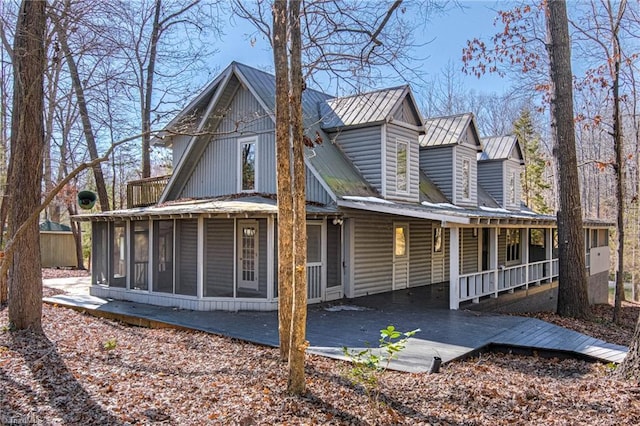 view of front of property featuring a sunroom and a deck