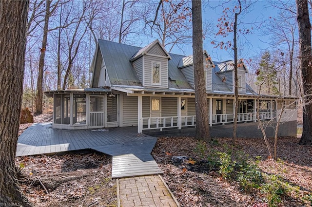 view of front facade with a deck and a sunroom