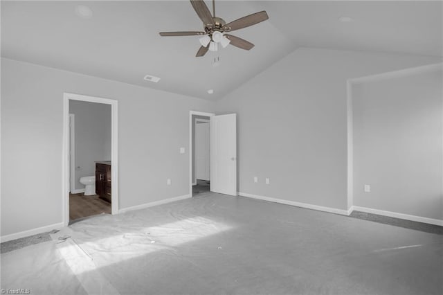 unfurnished bedroom featuring ceiling fan, light carpet, ensuite bathroom, and lofted ceiling