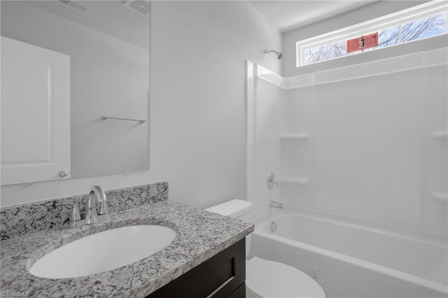 full bathroom featuring toilet, vanity, and shower / washtub combination