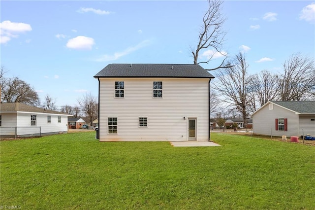 rear view of house featuring a patio area and a lawn