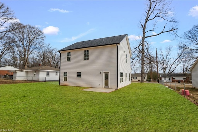 back of property with a lawn and a patio