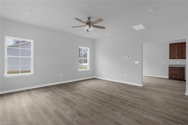 unfurnished living room featuring ceiling fan and hardwood / wood-style flooring