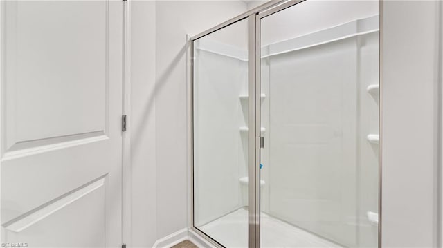 bathroom with a shower with door