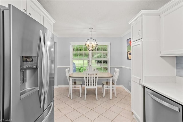6796 Ironwood Cir, Greensboro, NC 27410 - dining space featuring a chandelier, light tile patterned floors, baseboards, a textured ceiling, and ornamental molding
