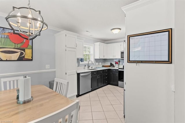 6796 Ironwood Cir, Greensboro, NC 27410 - kitchen featuring appliances with stainless steel finishes, a chandelier, crown molding, white cabinetry, and light tile patterned floors