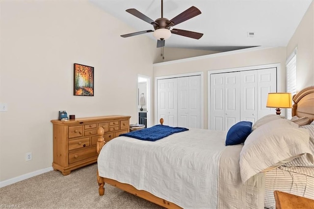 6796 Ironwood Cir, Greensboro, NC 27410 - bedroom with multiple closets, vaulted ceiling, light carpet, baseboards, and ceiling fan