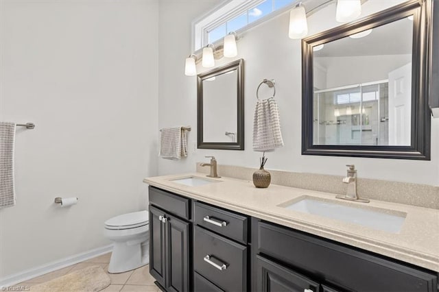 6796 Ironwood Cir, Greensboro, NC 27410 - bathroom featuring toilet, double vanity, tile patterned floors, a shower with shower door, and baseboards