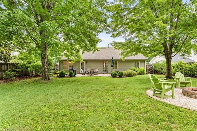6796 Ironwood Cir, Greensboro, NC 27410 - back of property featuring a patio area and an outdoor fire pit