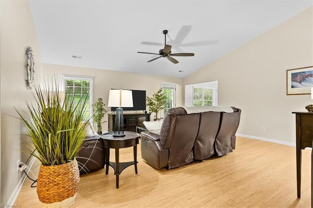 6796 Ironwood Cir, Greensboro, NC 27410 - living area featuring light wood finished floors, plenty of natural light, a ceiling fan, and vaulted ceiling