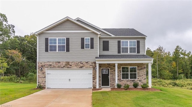 craftsman inspired home featuring a front yard, concrete driveway, a garage, and stone siding