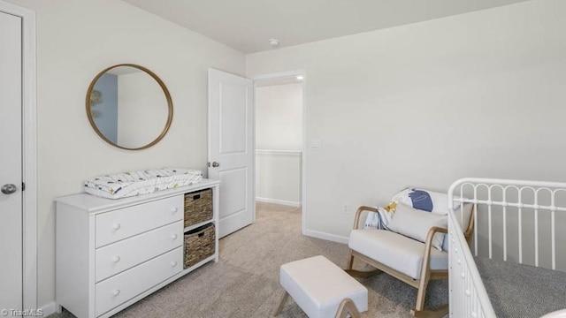 bedroom featuring light colored carpet and baseboards