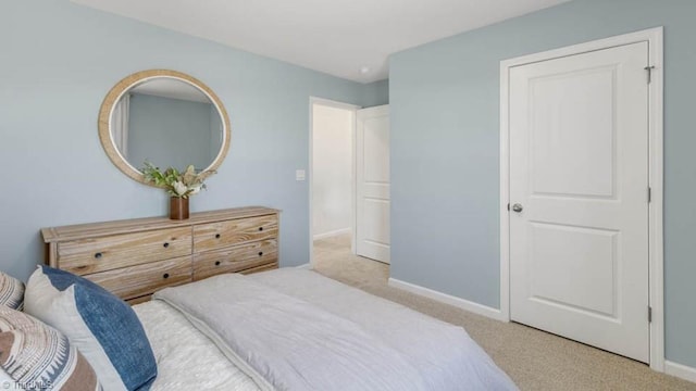 bedroom featuring carpet and baseboards