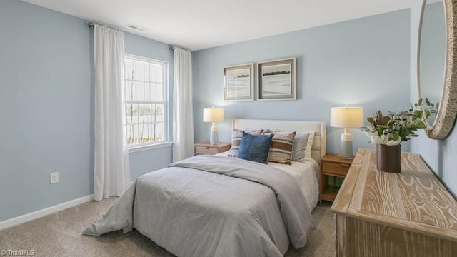 carpeted bedroom featuring visible vents and baseboards